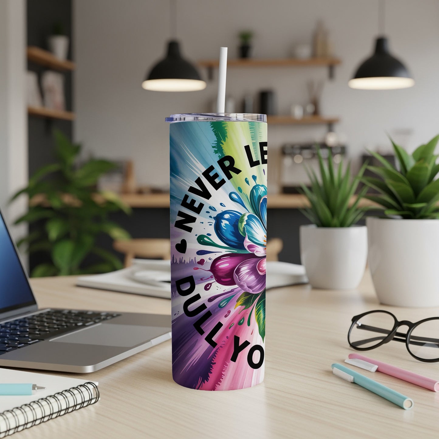 Tumbler with colorful floral splash design and "NEVER LET ANYONE DULL YOUR SPARKLE" text.