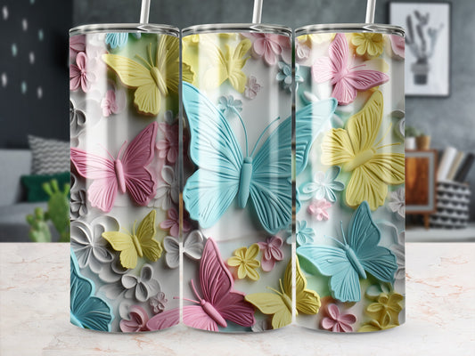 Three tumblers with pastel butterflies and floral designs.