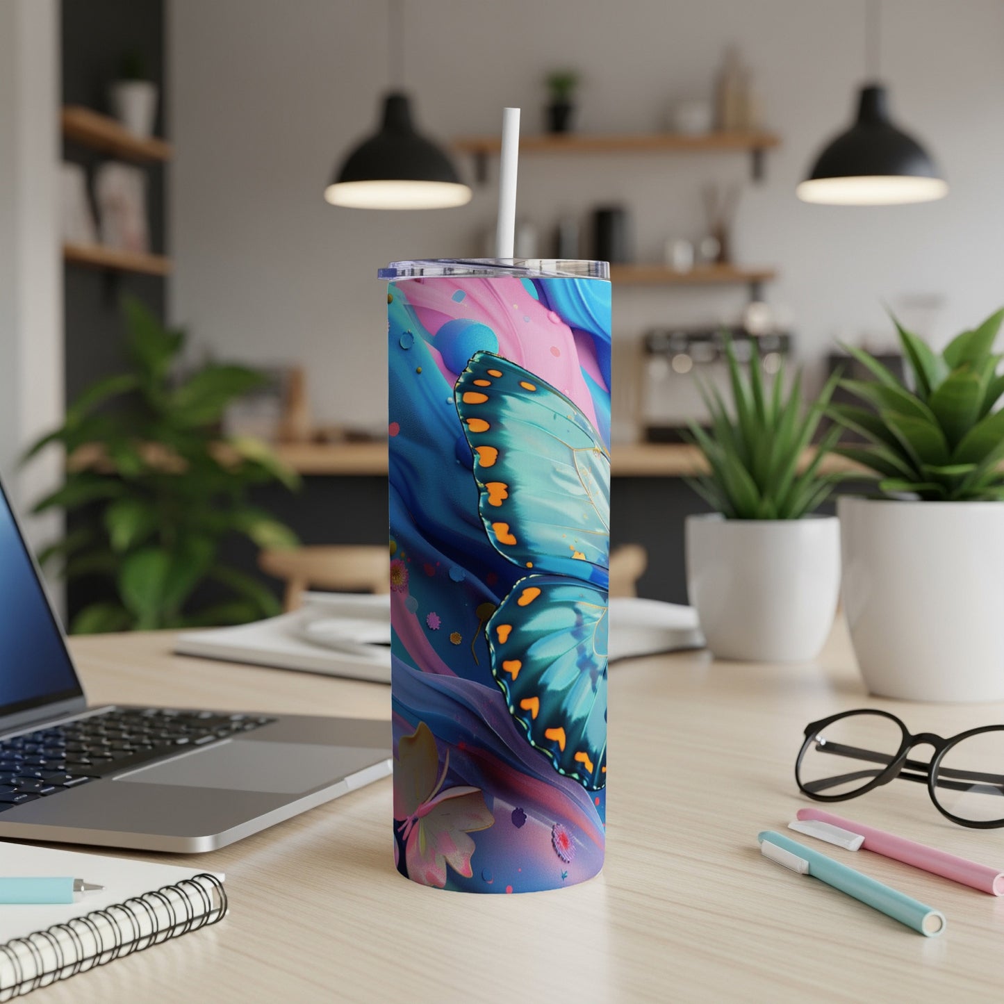 Blue butterfly on a pink and blue abstract background, on a white tumbler with straw.