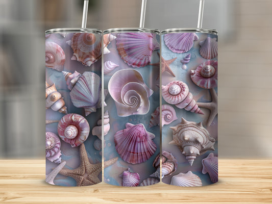 Three tumblers with seashell and starfish designs on a wooden surface.
