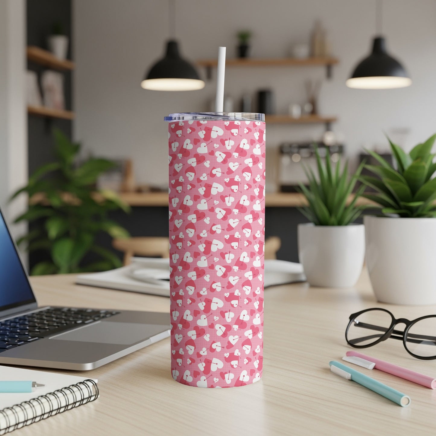 Pink tumbler with white and pink hearts and arrows pattern, includes straw