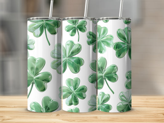 Three tumblers with a seamless pattern of green shamrocks.