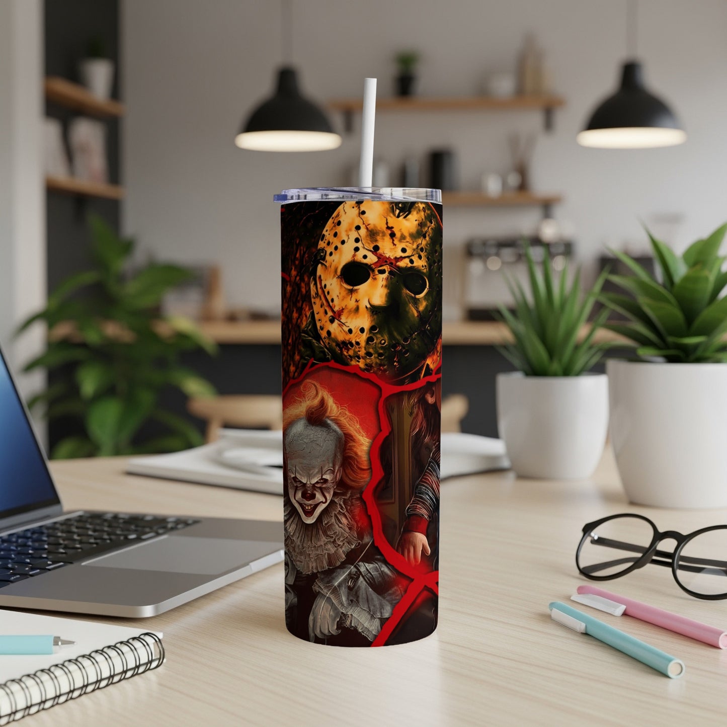 Tumbler featuring Jason Voorhees, Pennywise, and Chucky on a desk.