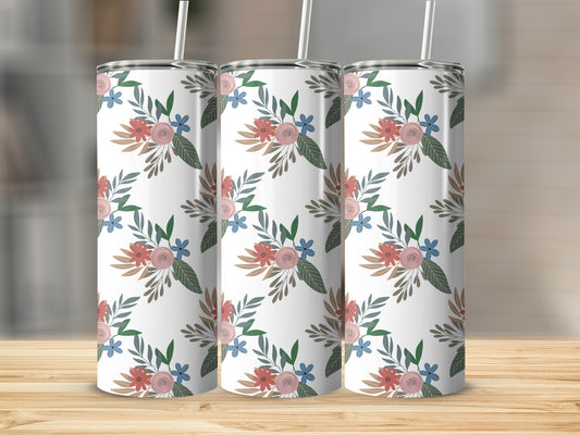 Three tumblers with a floral pattern on a wooden surface.