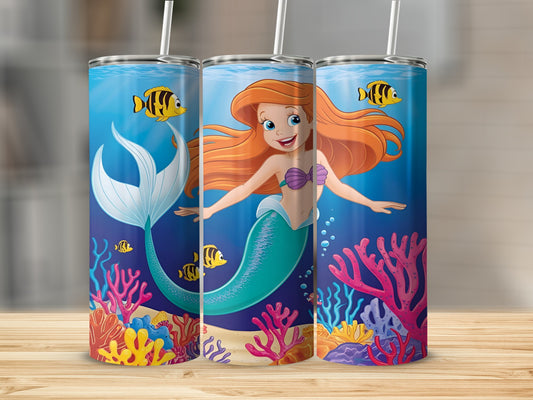 Ariel the mermaid swims among coral and fish in a blue ocean.