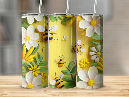 Three tumblers with a bee and floral design, set on a wooden surface.