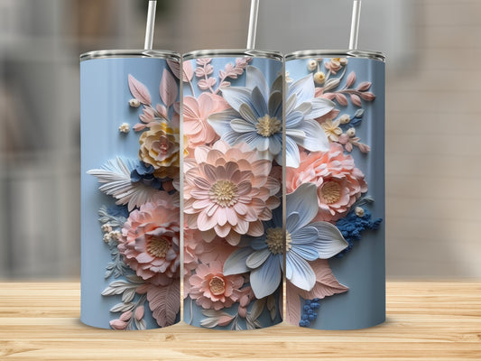 Three blue tumblers with embossed floral designs in pink and white.