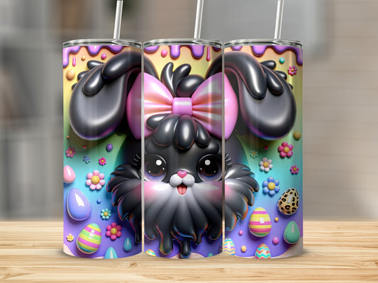 Black bunny with pink bow and colorful Easter eggs on a tumbler.