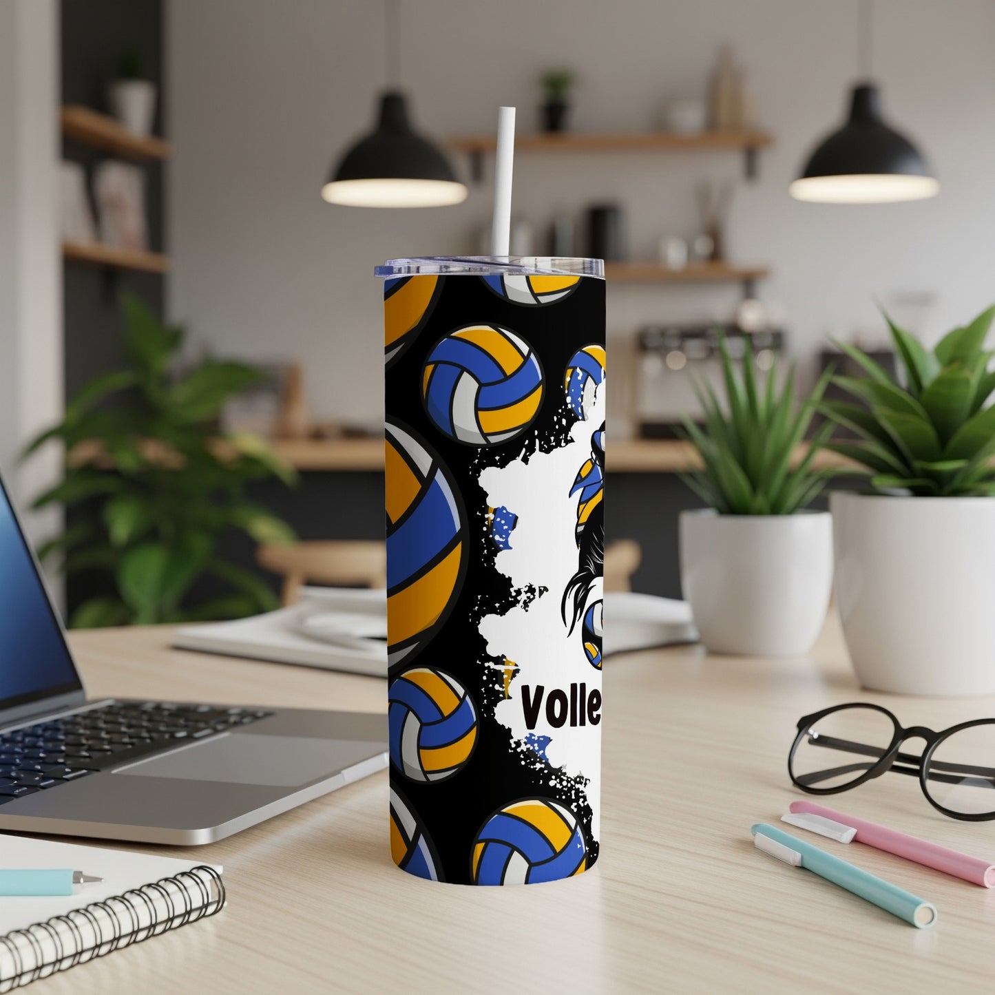 Black tumbler with volleyballs and "Volley" text, on a desk.