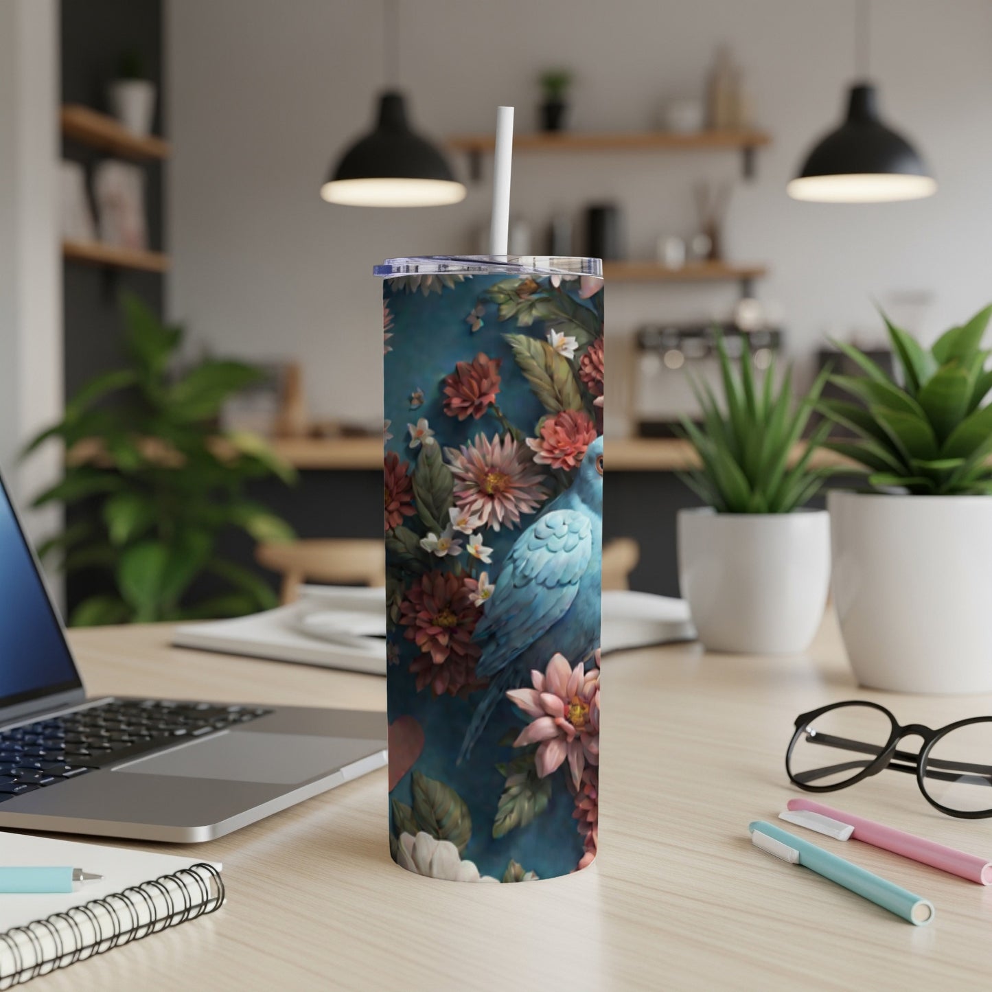 Blue bird and flowers pattern on a white skinny tumbler.