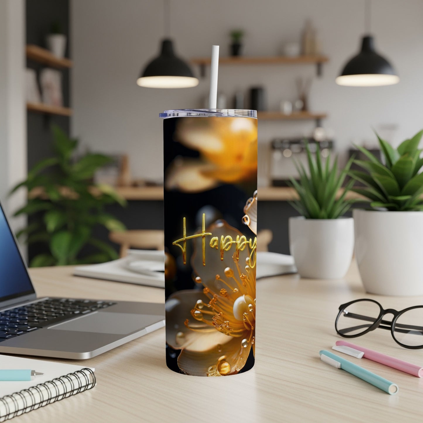 Gold "Happy" text on a tumbler with blooming yellow flowers and water droplets.