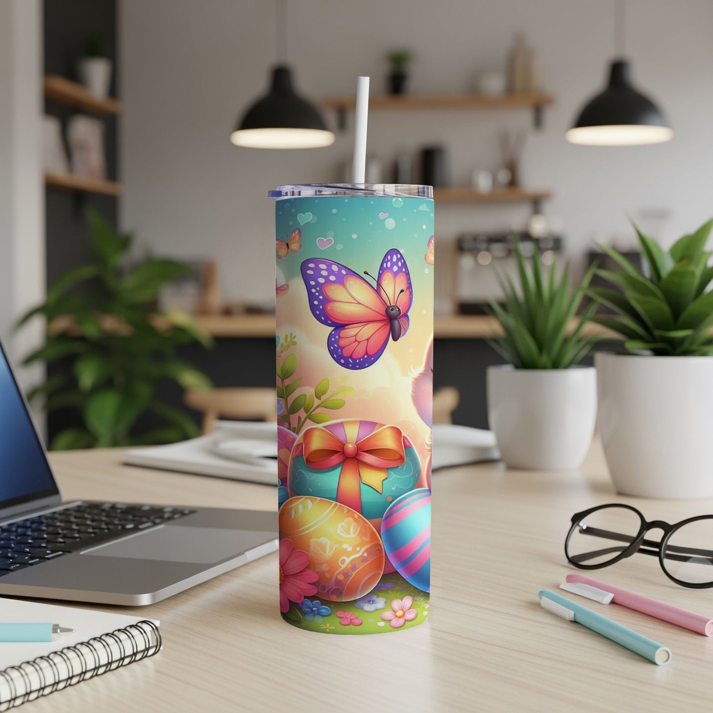 Butterfly and Easter egg design on a tumbler with a straw.