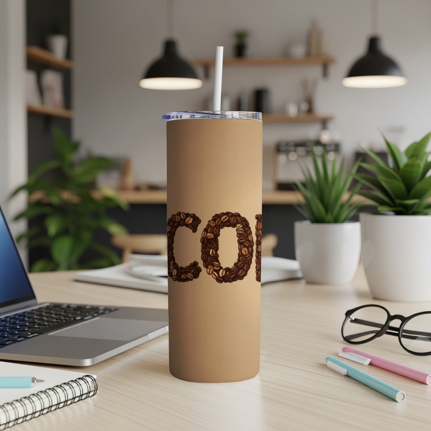 Brown tumbler with "COFFEE" spelled out in coffee beans.