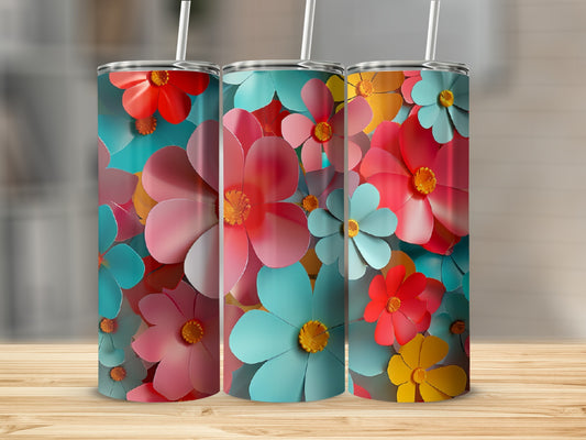 Three tumblers with a repeating pattern of colorful floral designs on a wooden surface.