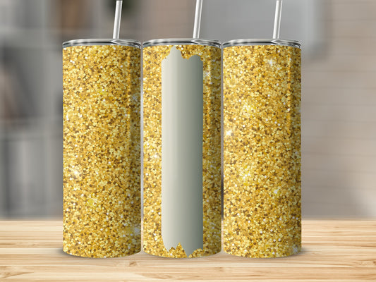 Three gold glitter tumblers with straws on a wooden surface.