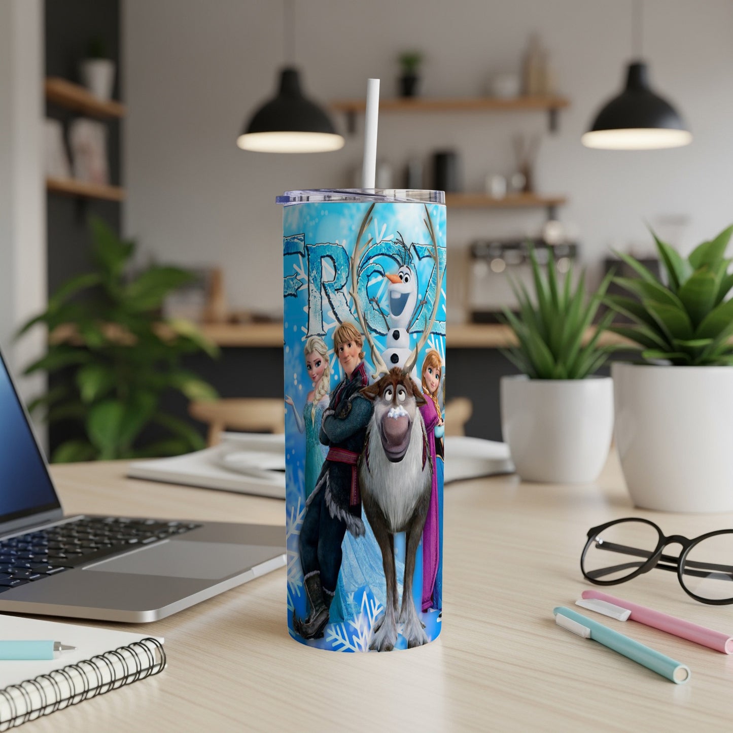Elsa, Anna, Kristoff, and Olaf from Frozen on a blue, snowflake-patterned tumbler.