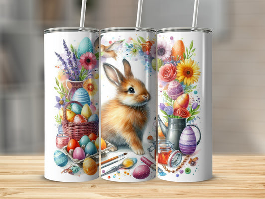 Easter-themed tumbler with a rabbit, painted eggs, and flowers.