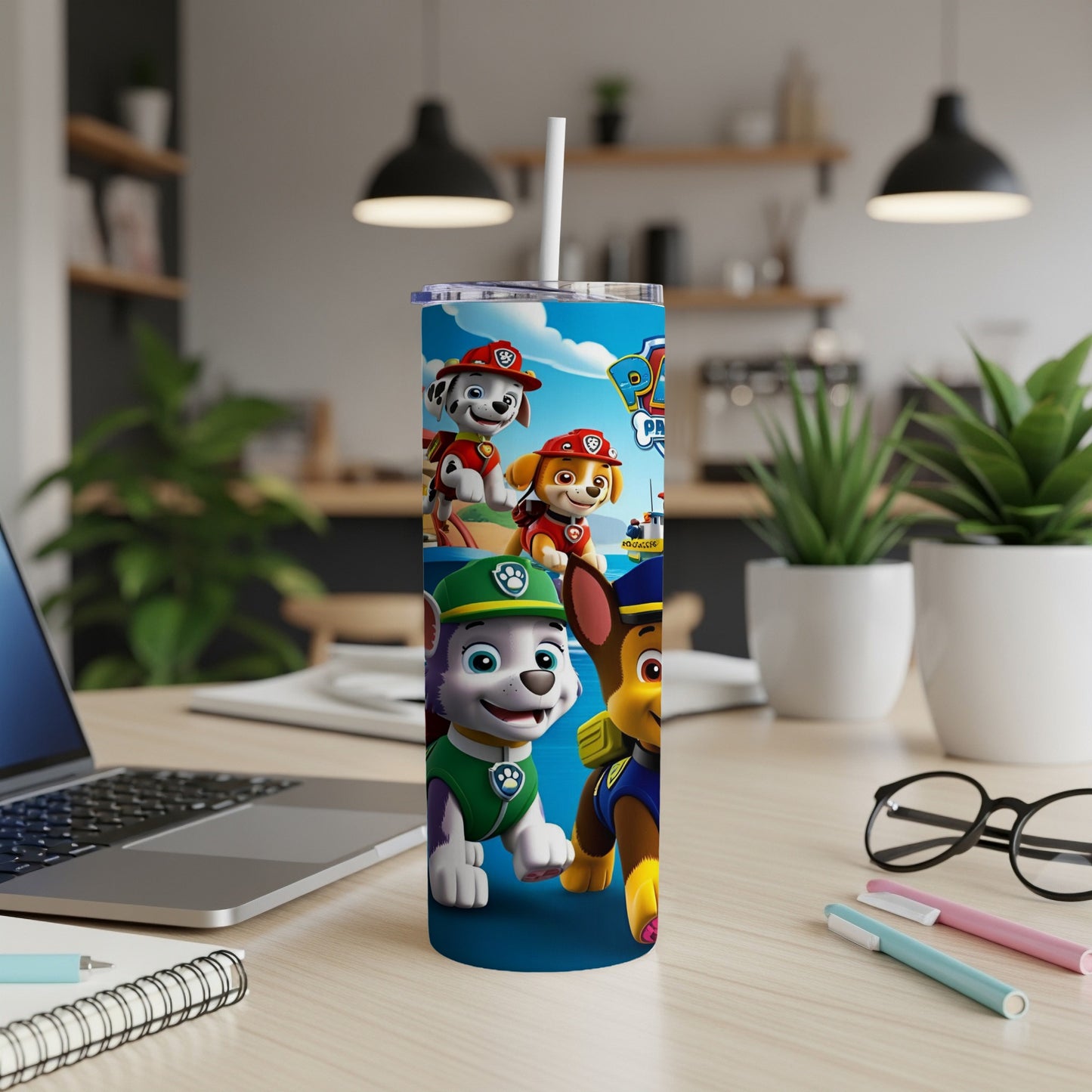 Paw Patrol characters Chase and Marshall on a blue tumbler with a white lid and straw.
