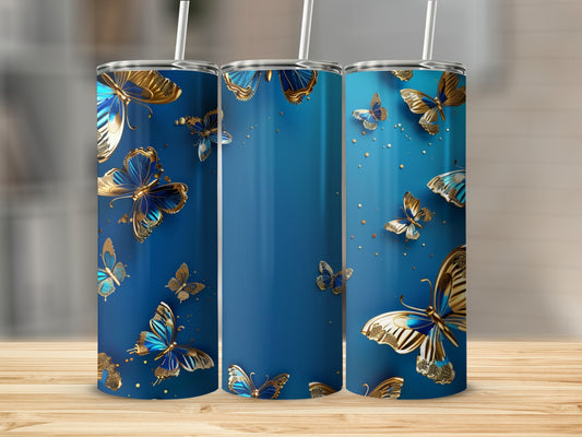 Blue tumbler with golden butterflies, straw inserted, on wooden surface.