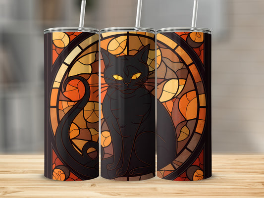 Black cat on stained glass with warm, autumnal tones.