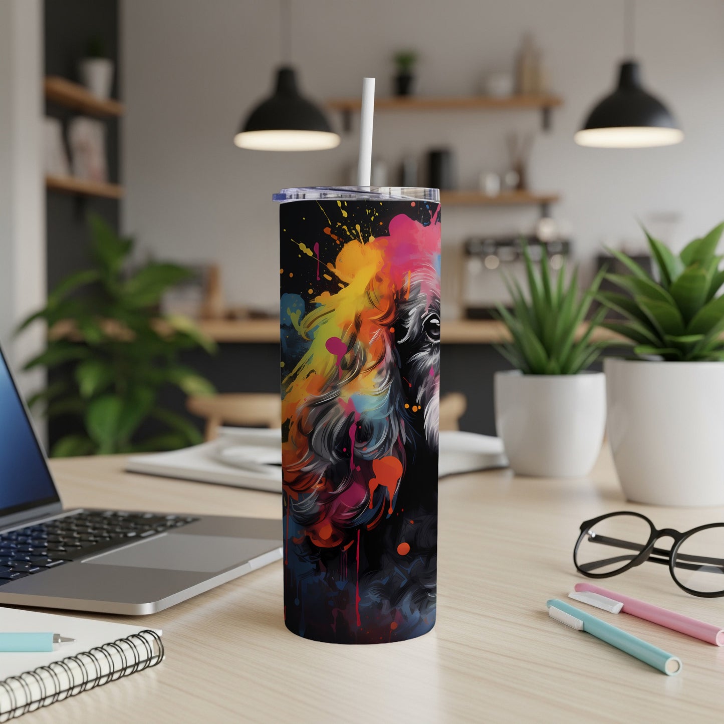 Black tumbler with abstract colorful dog portrait and white straw.