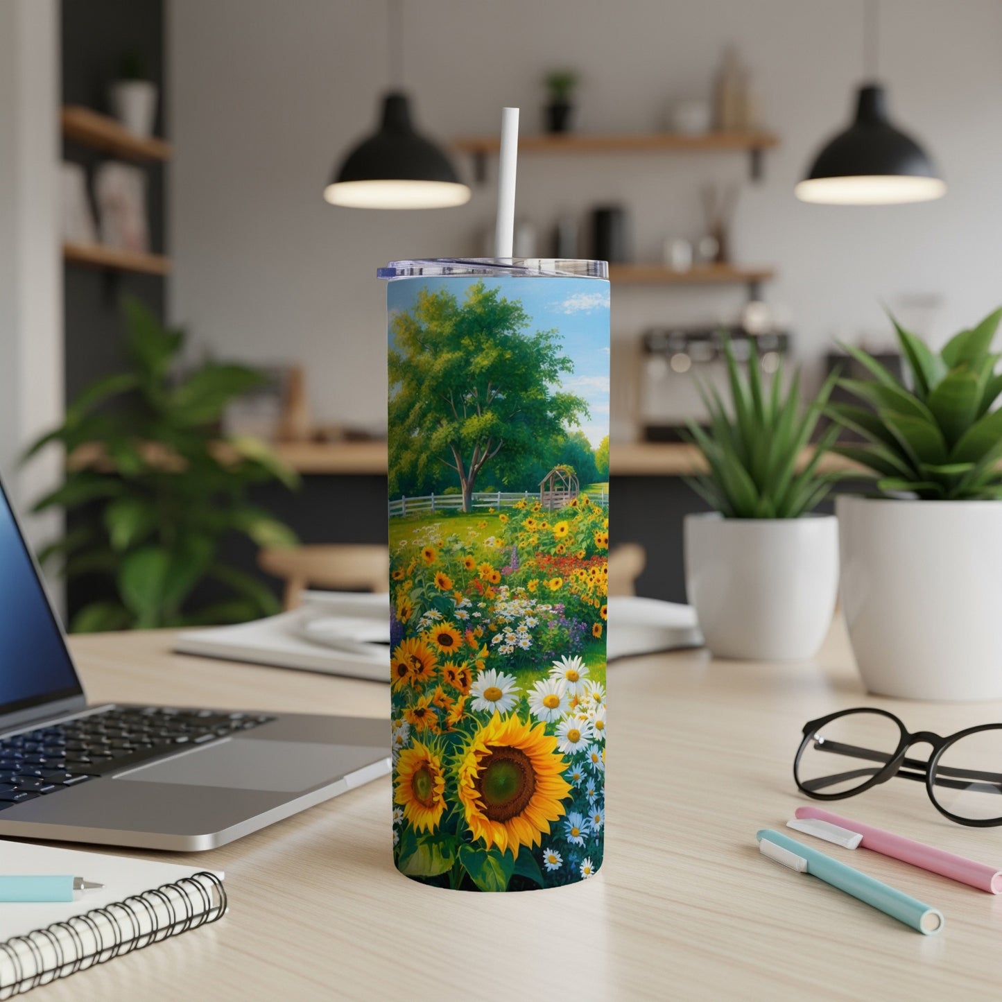 Sunflower field on a tumbler with a straw, displayed on a desk.