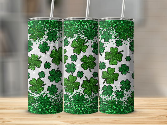 Three green glitter shamrock print tumblers with white straws.