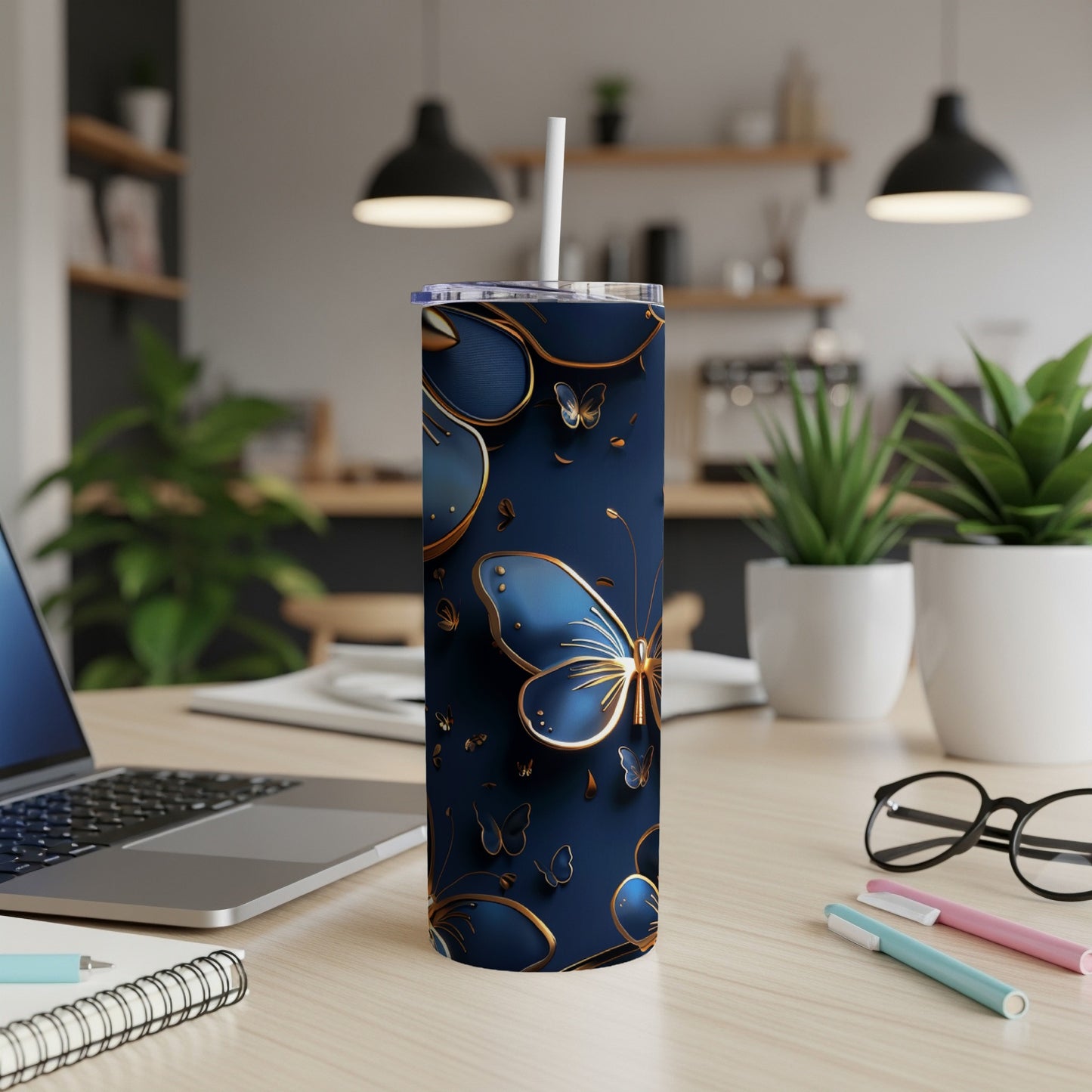 Dark blue tumbler with gold butterfly accents and white straw.