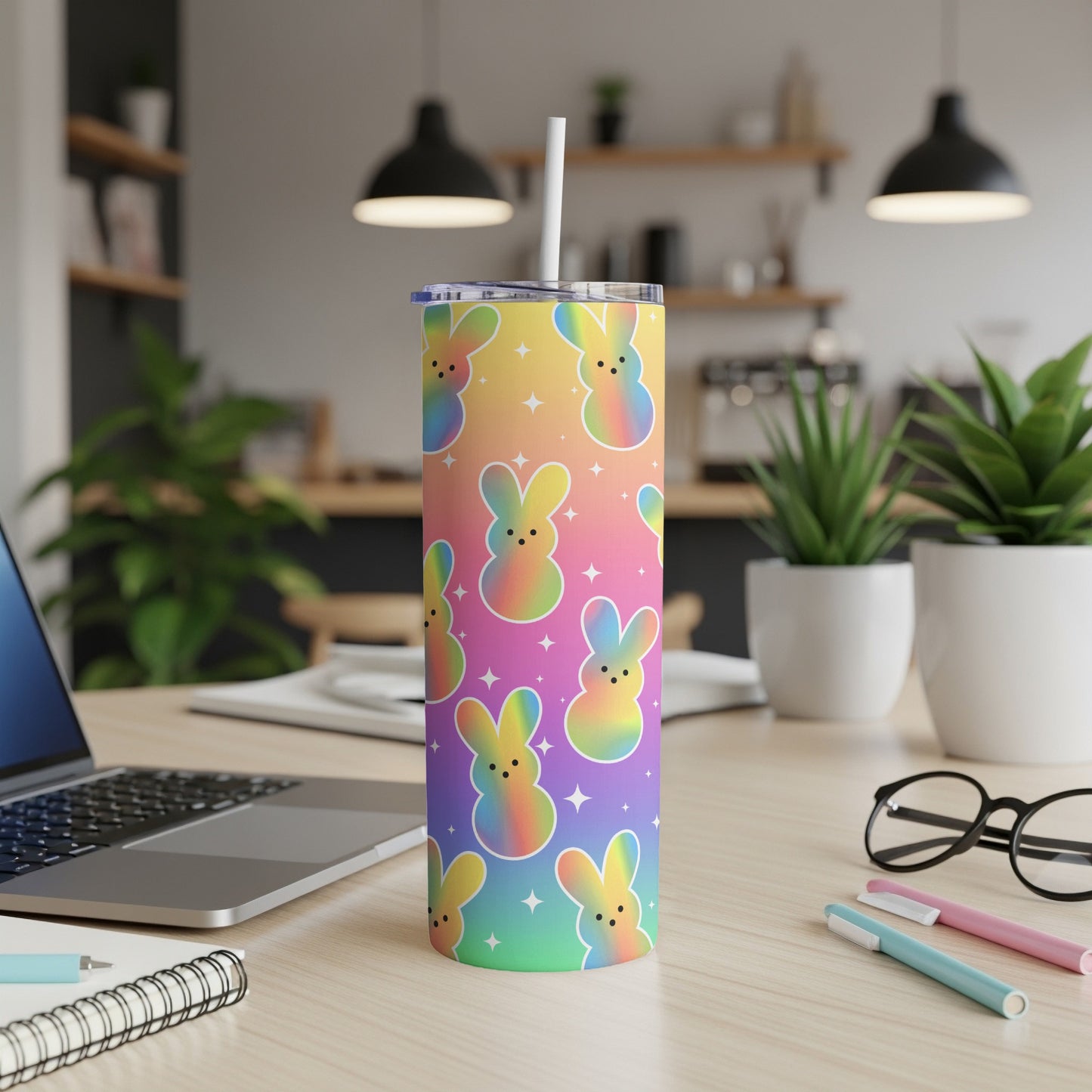 Rainbow Peeps Easter bunny tumbler with straw on a desk.