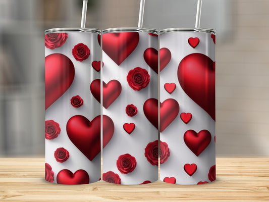 Three tumblers with red hearts and roses pattern on a wooden surface.