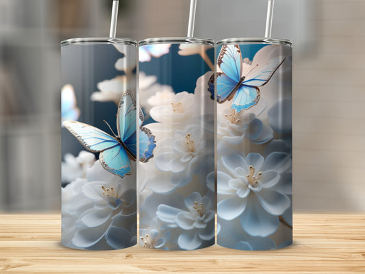 Blue butterflies and white flowers on a tall, slender tumbler.