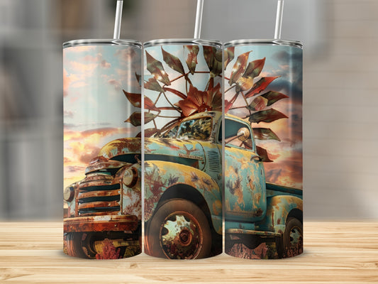 Rusty vintage truck with windmill blades against a sunset sky.