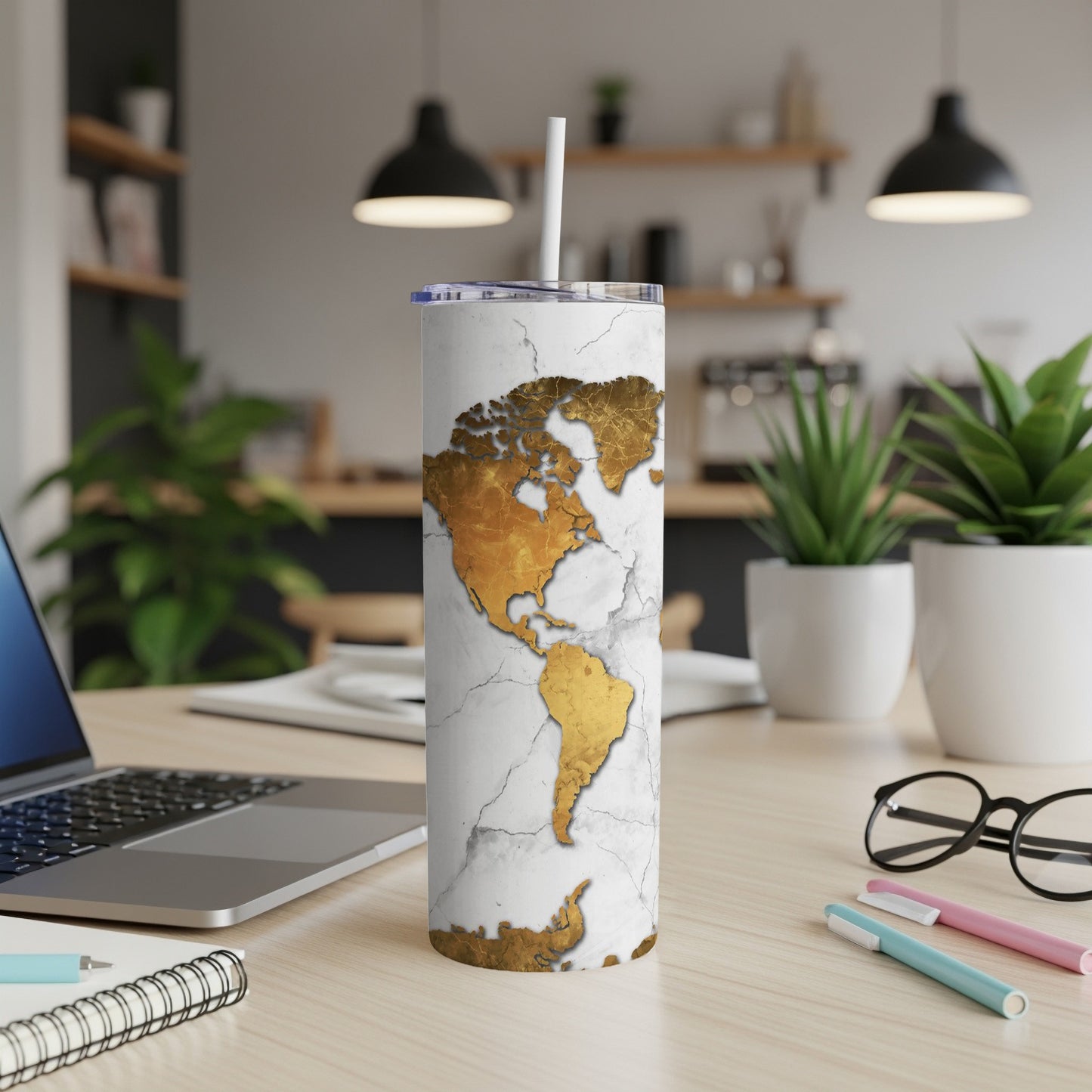 White marble tumbler with gold world map design and white straw.