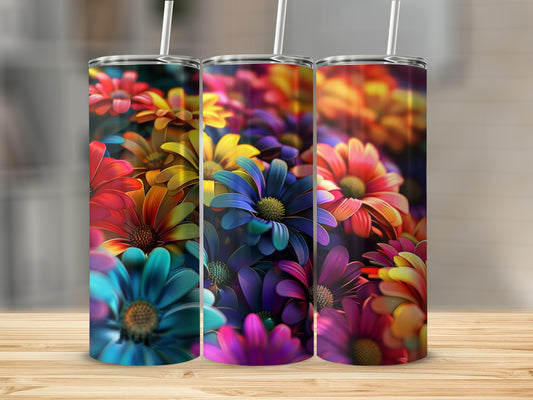 Three tumblers with colorful floral designs displayed on a wooden surface.