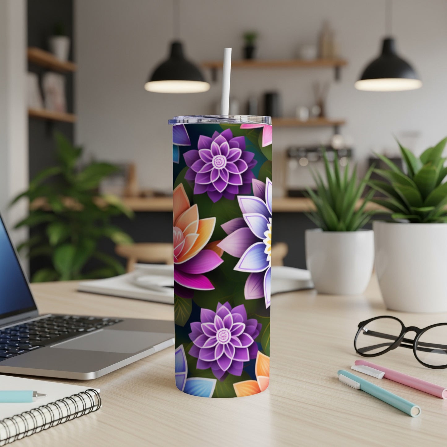 Purple, pink, and blue floral pattern on a white tumbler with a straw.