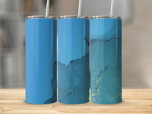 Three tumblers with blue and gold marble design on a wooden surface.