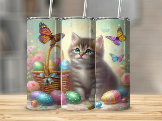 Kitten and Easter eggs with butterflies in a basket.