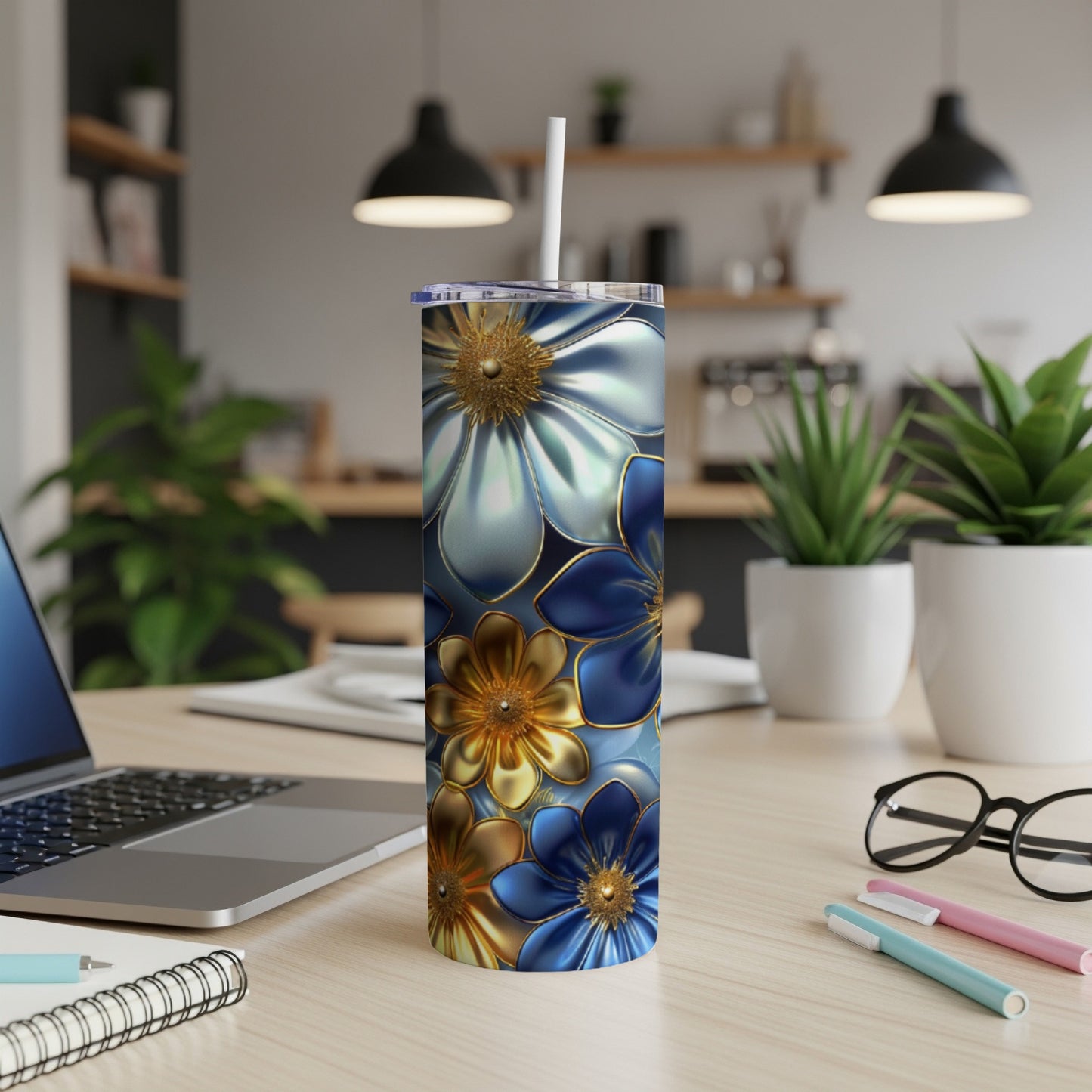 Blue and gold floral patterned tumbler with a straw.