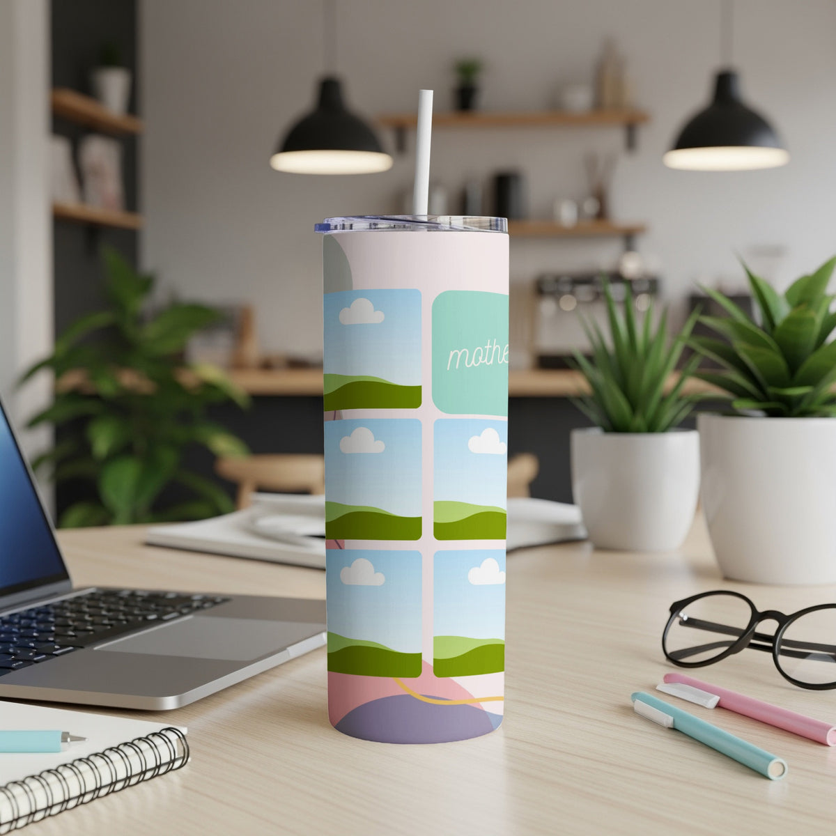Tall tumbler with a colorful abstract design and "mother" text, set on a desk.