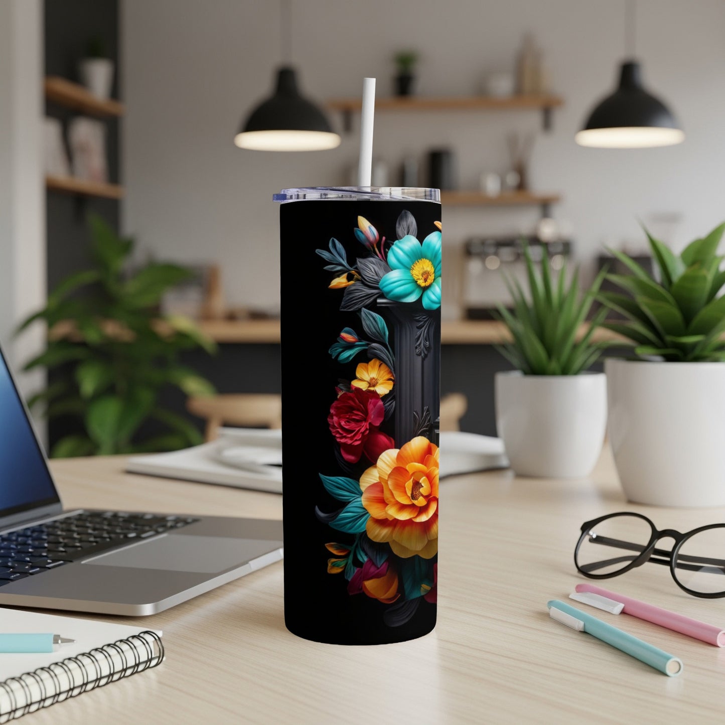 Black tumbler with vibrant floral design and white straw.