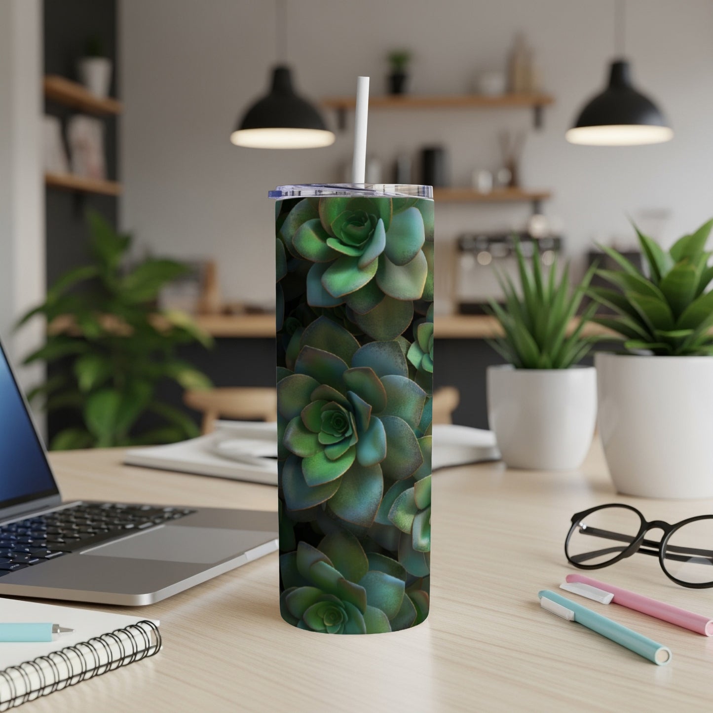 Green succulent pattern on a white tumbler with a straw.