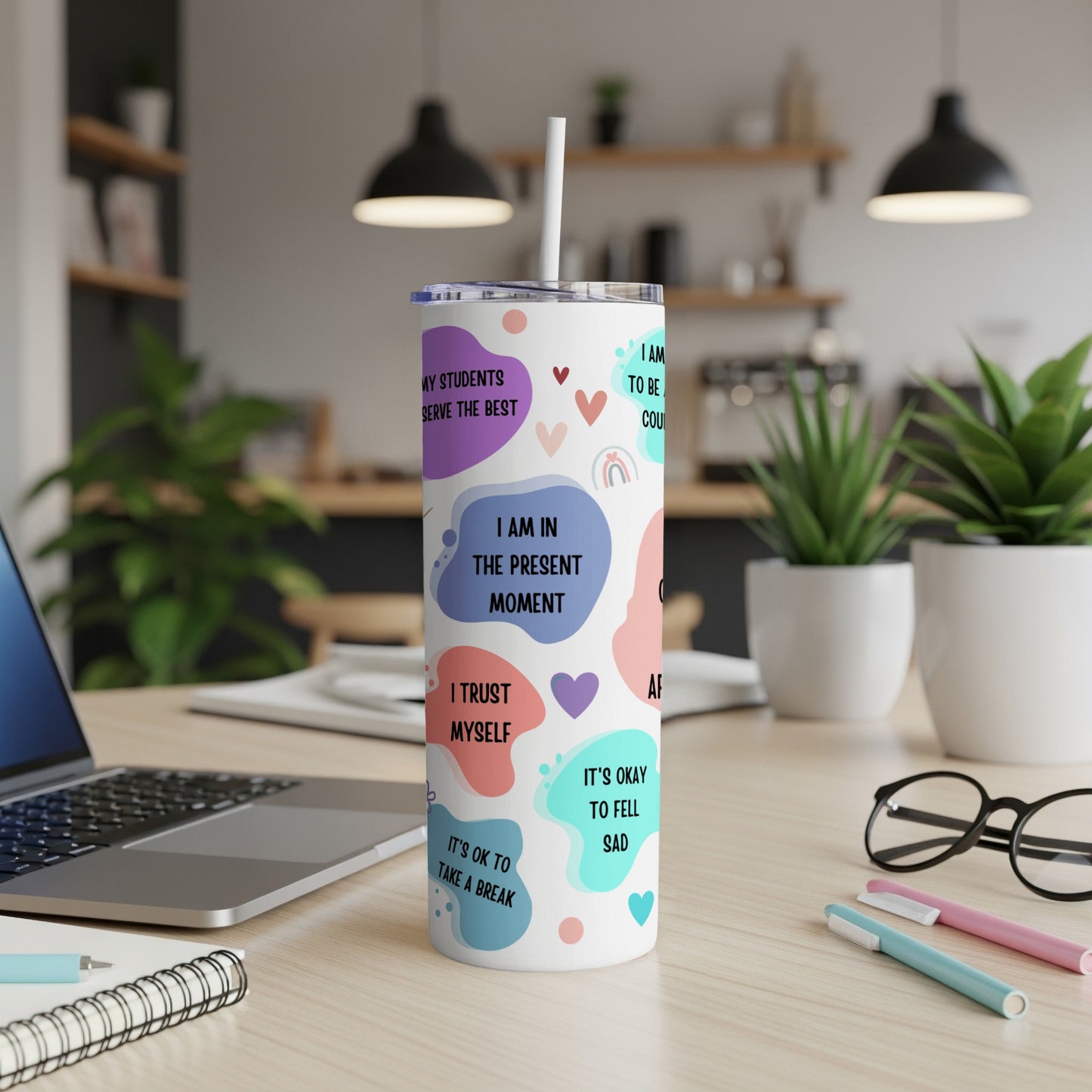 Tumbler with colorful abstract shapes and text about self-care and teaching.