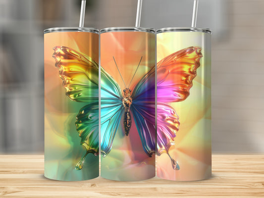 Three tumblers with iridescent butterfly designs in front of a blurred background.