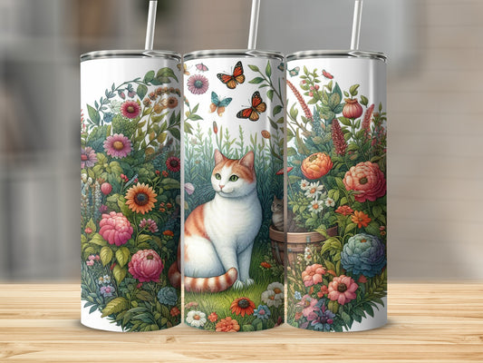 White tumbler with a cat sitting among wildflowers and butterflies.