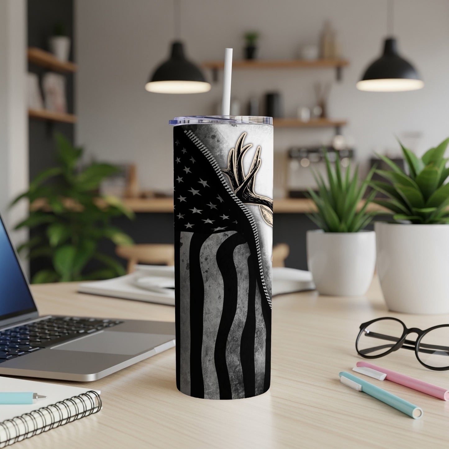 Tumbler with American flag design and deer antlers, with straw.