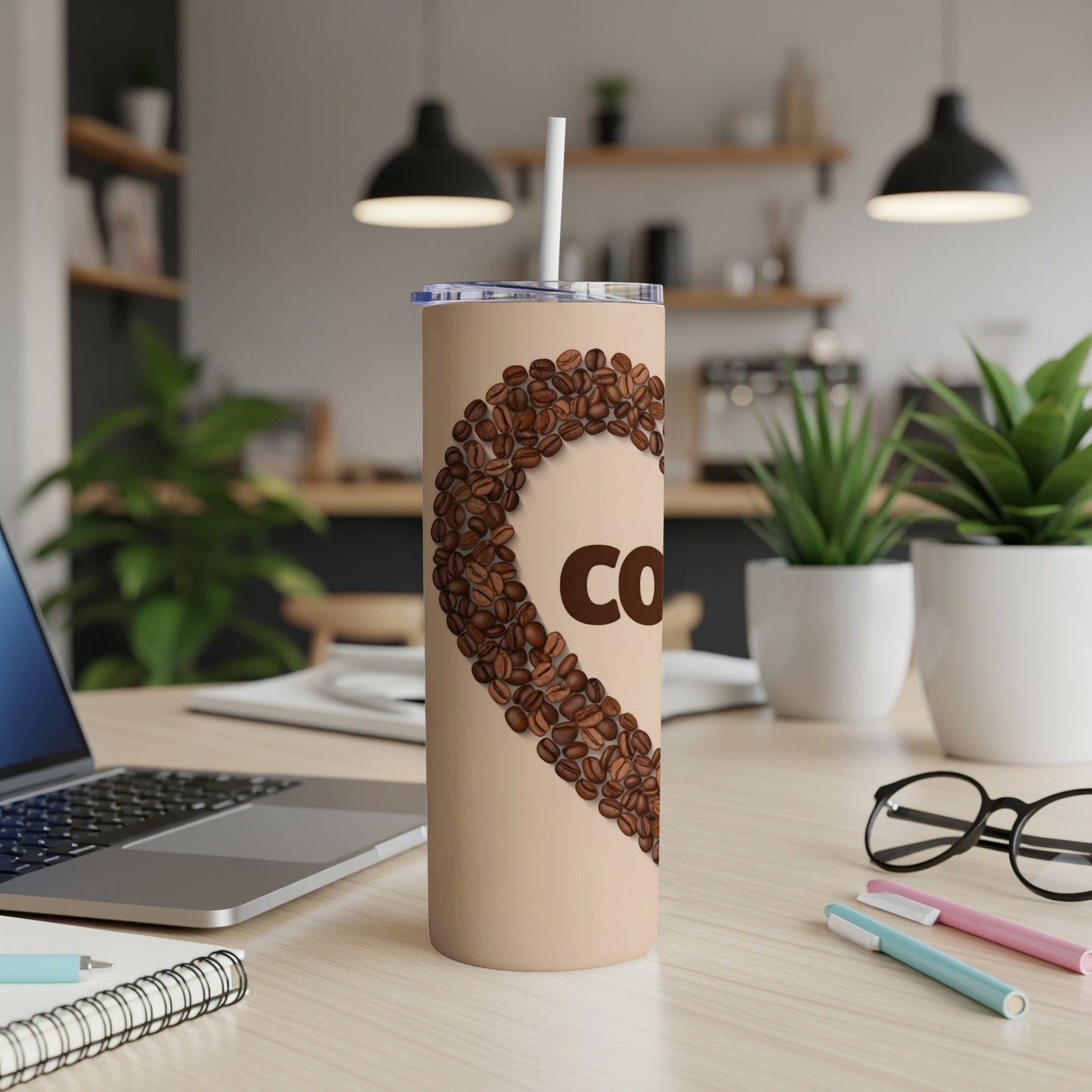 Tan tumbler with heart shape formed by coffee beans, "COFFEE" text.
