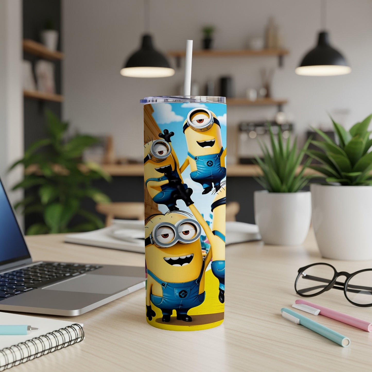 Minions in blue overalls on a yellow tumbler with a straw.