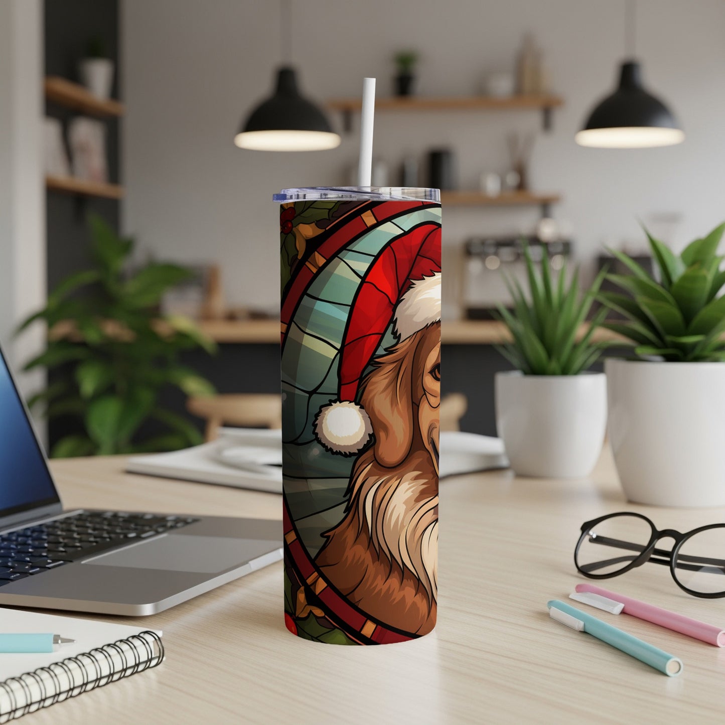 Santa dog tumbler with straw on a desk.