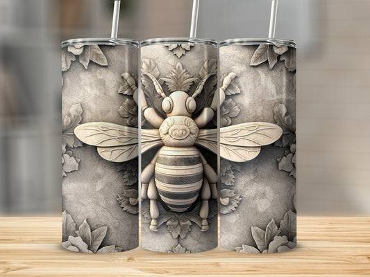 Three textured tumblers featuring a raised, ornate bee design on a stone-like background.