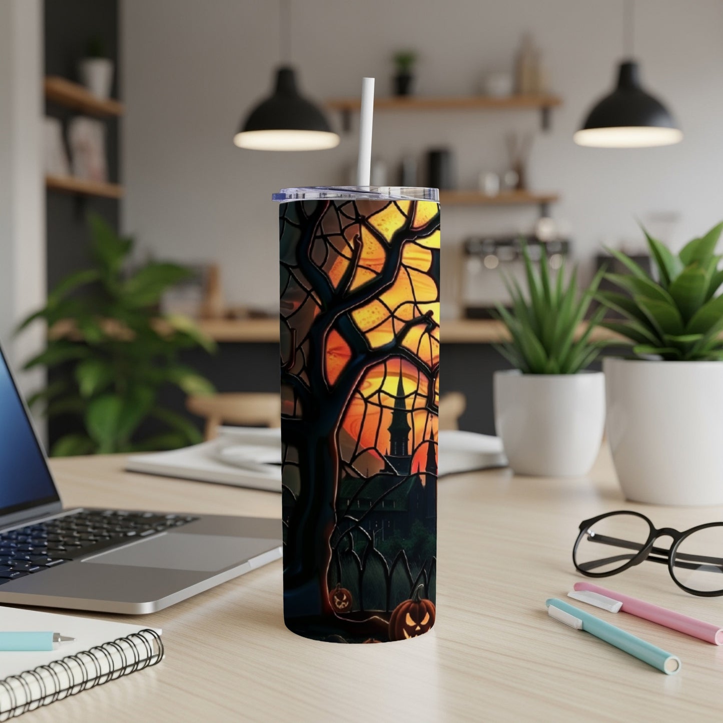 Halloween tumbler with a haunted castle and pumpkins against a sunset sky.